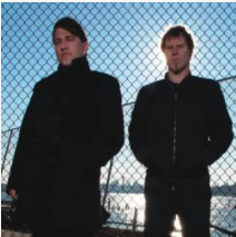 Dulli and Lanegan aka Gutter Twins standing in front of a chain link fence