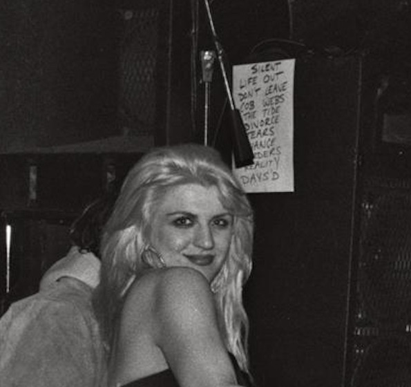 detail image showing set list behind Courtney posing near stage