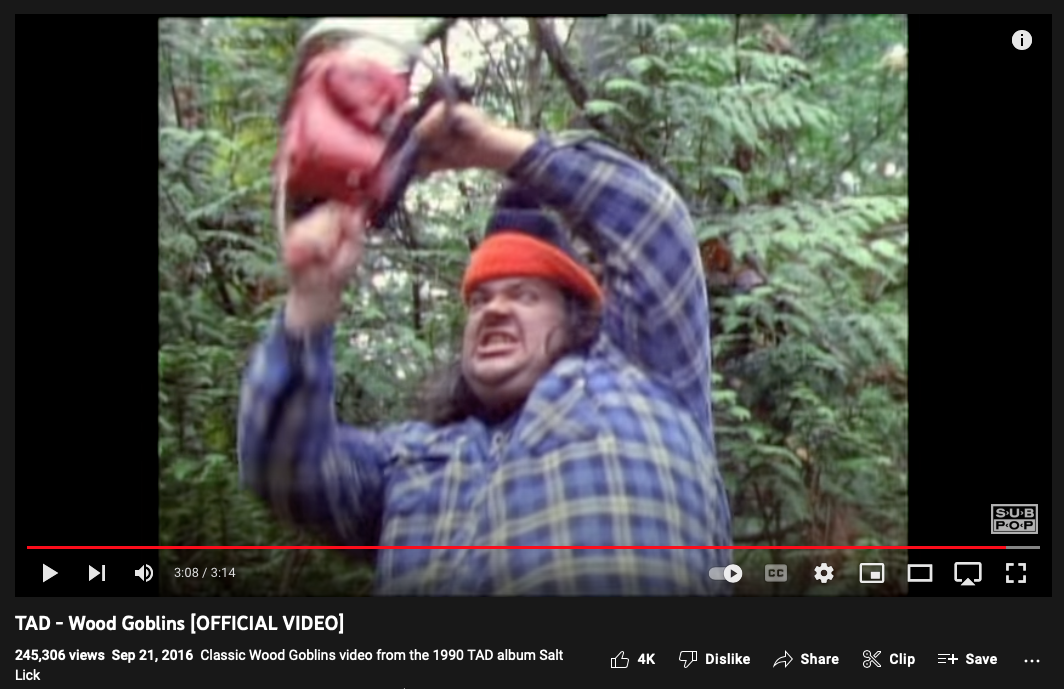 video still showing Tad Doyle holding chainsaw in air like a murder weapon