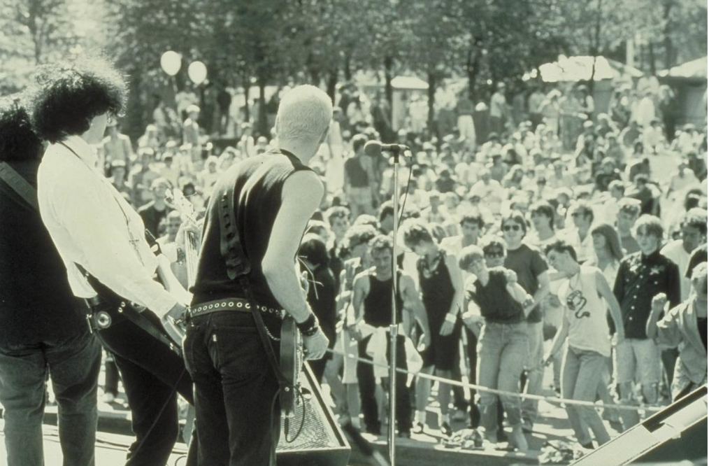 black and white photo of Napalm Beach viewed from behind on stage, dancing crowd