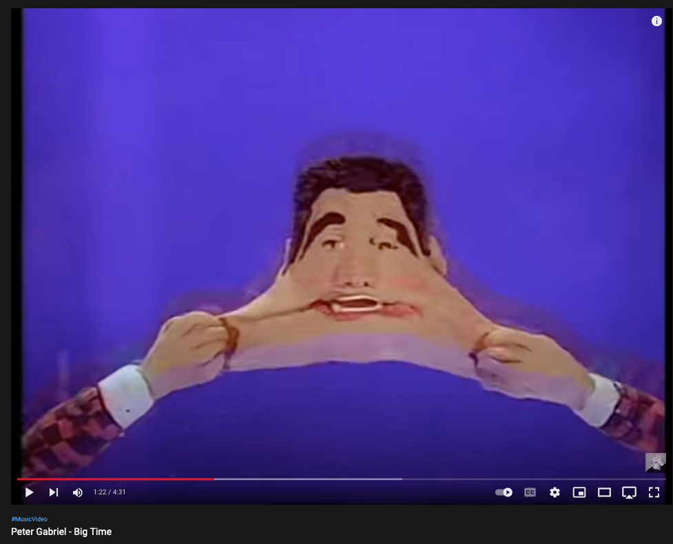 still from Peter Gabriel "Big Time" showing man with "stretched" mouth